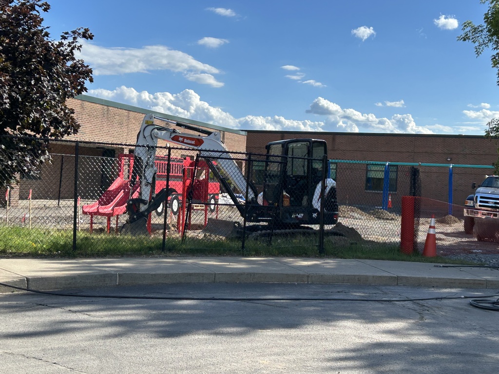 view of digger and new playground unit