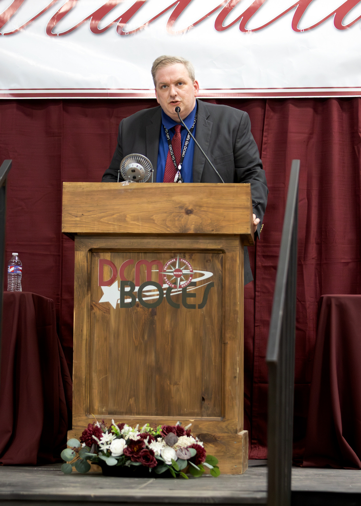 Principal speaks at lectern