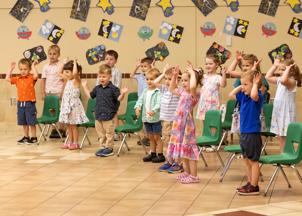 preschool children doing movements and singing