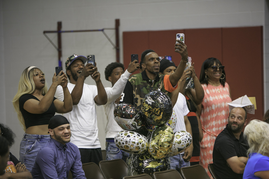 excited family taking pictures from the audience