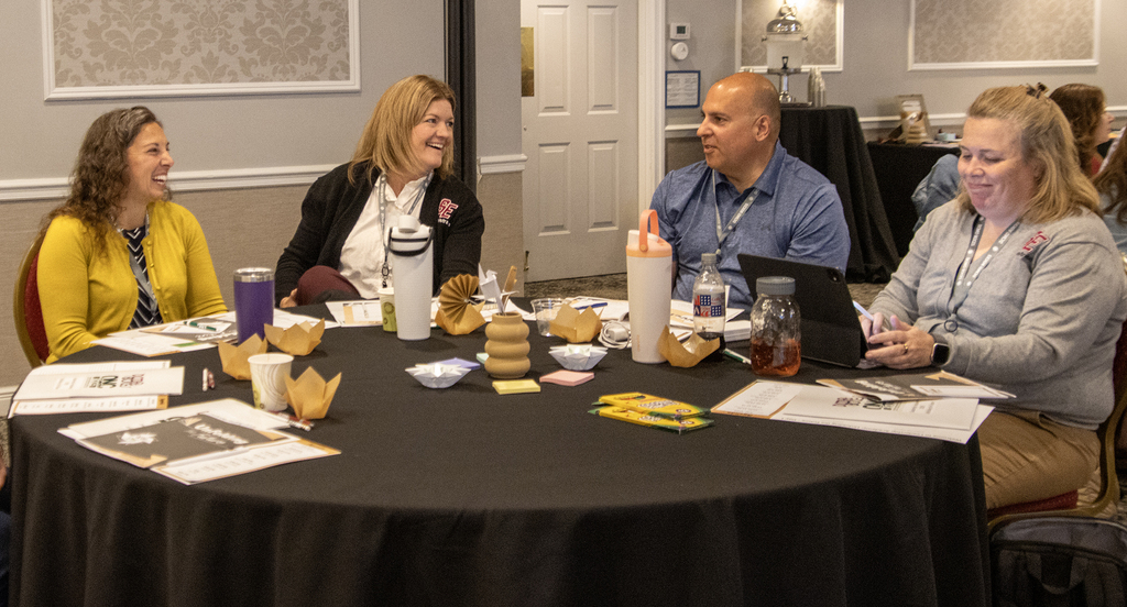 participants laugh at a table