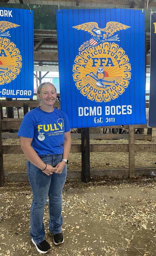 FFA student next to DCMO BOCES FFA banner
