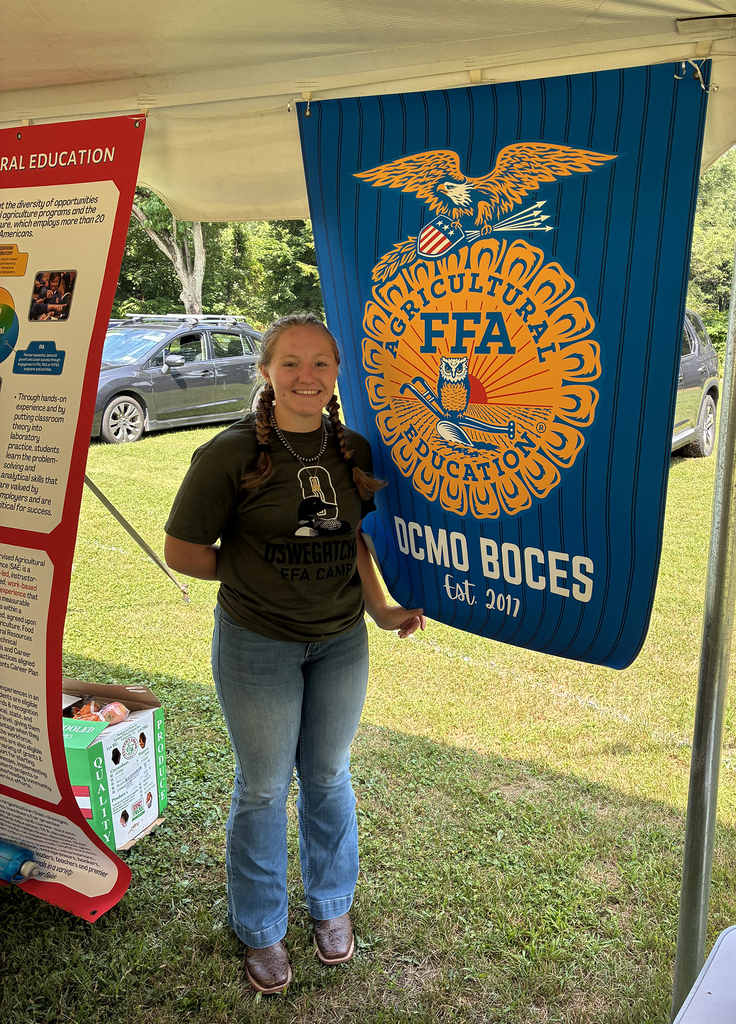 FFA student next to DCMO BOCES FFA banner