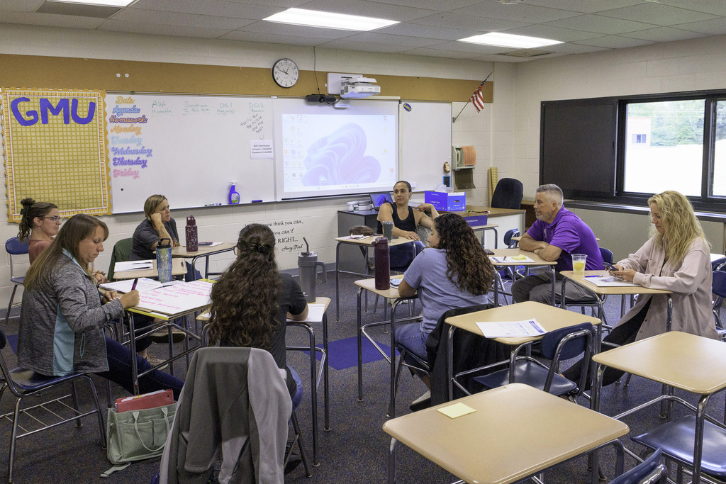 participants sit in a circle in a breakout room