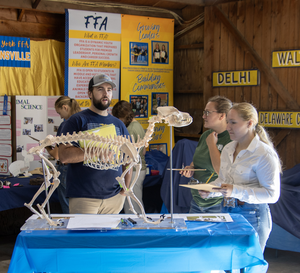 Two FFA advisors and a student at the anatomy station
