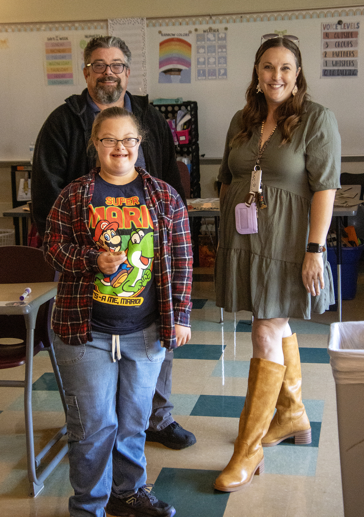 smiling student with smiling parents