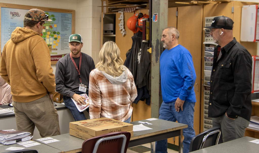 Teacher talking to student and family members