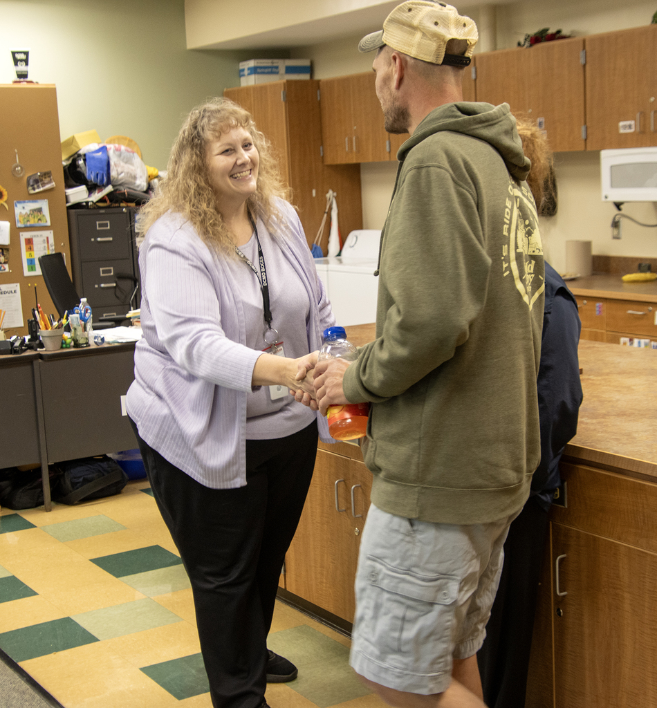 Teacher shakling hands with a parent