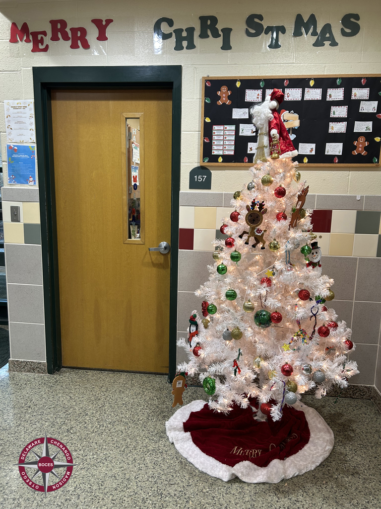 Merry Christmas sign and a decorated white Christmas tree