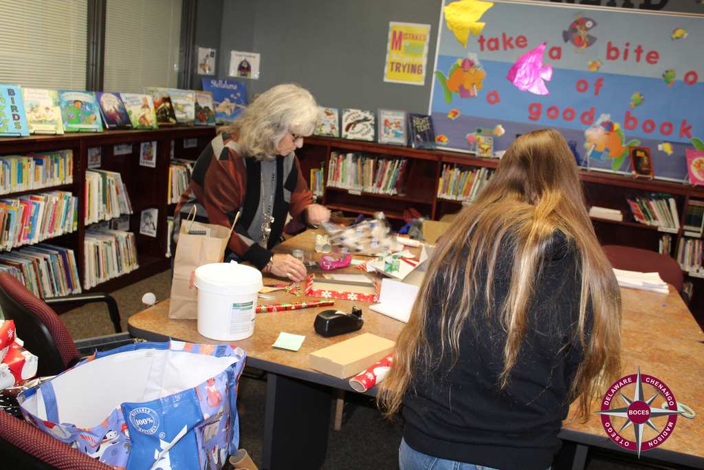 two people wrapping presents