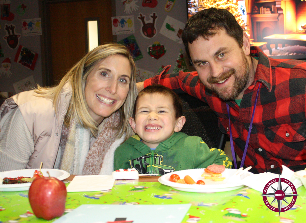 photo of two adults and child at party