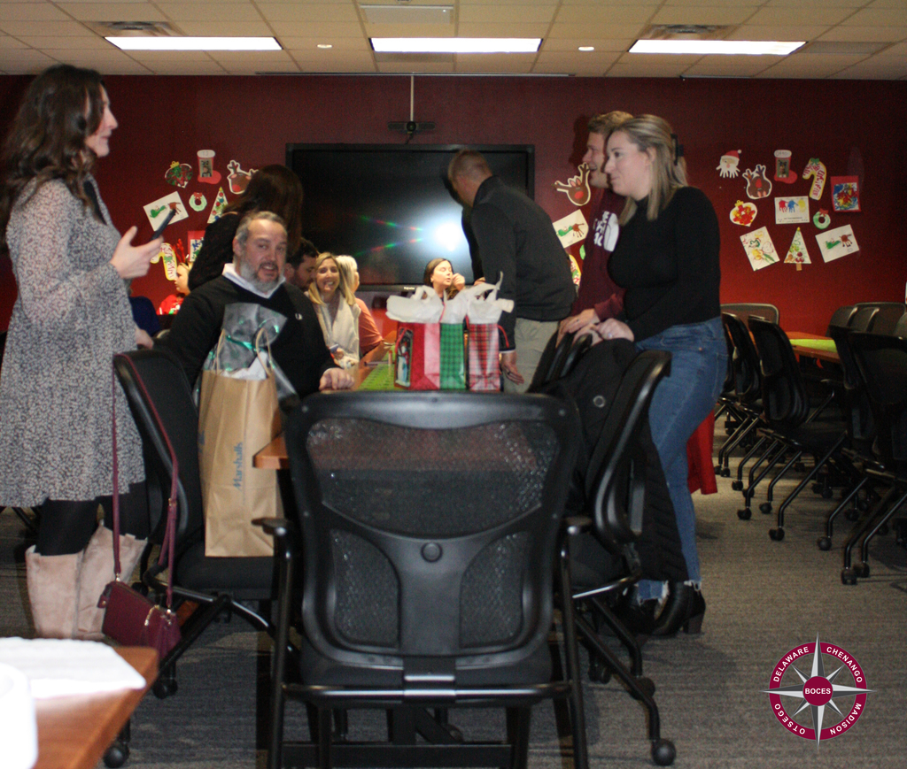 photo of adults sitting and standing at party