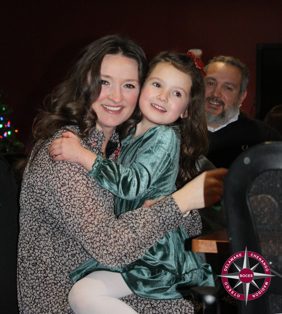 photo of two adults and child at party
