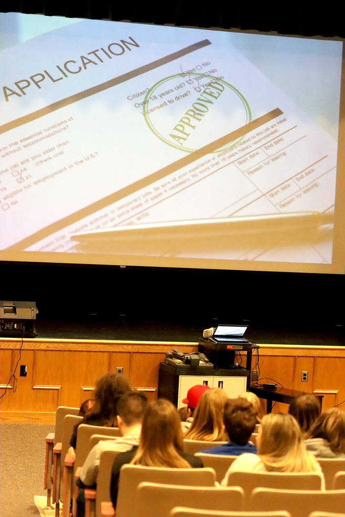 students in an auditorium watch a  CTE video