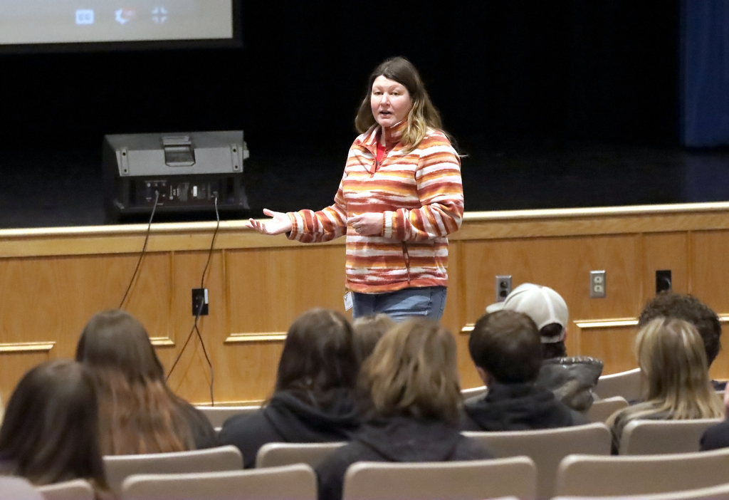 adult presenting in front of auditorium