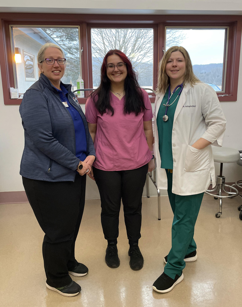 two adults and a student at veterinary clinic