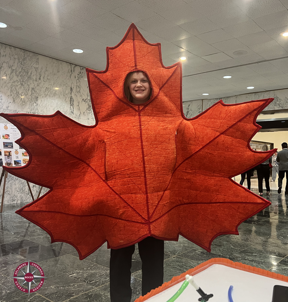 student in maple leaf costume