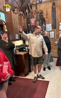 man in shorts pointing to something