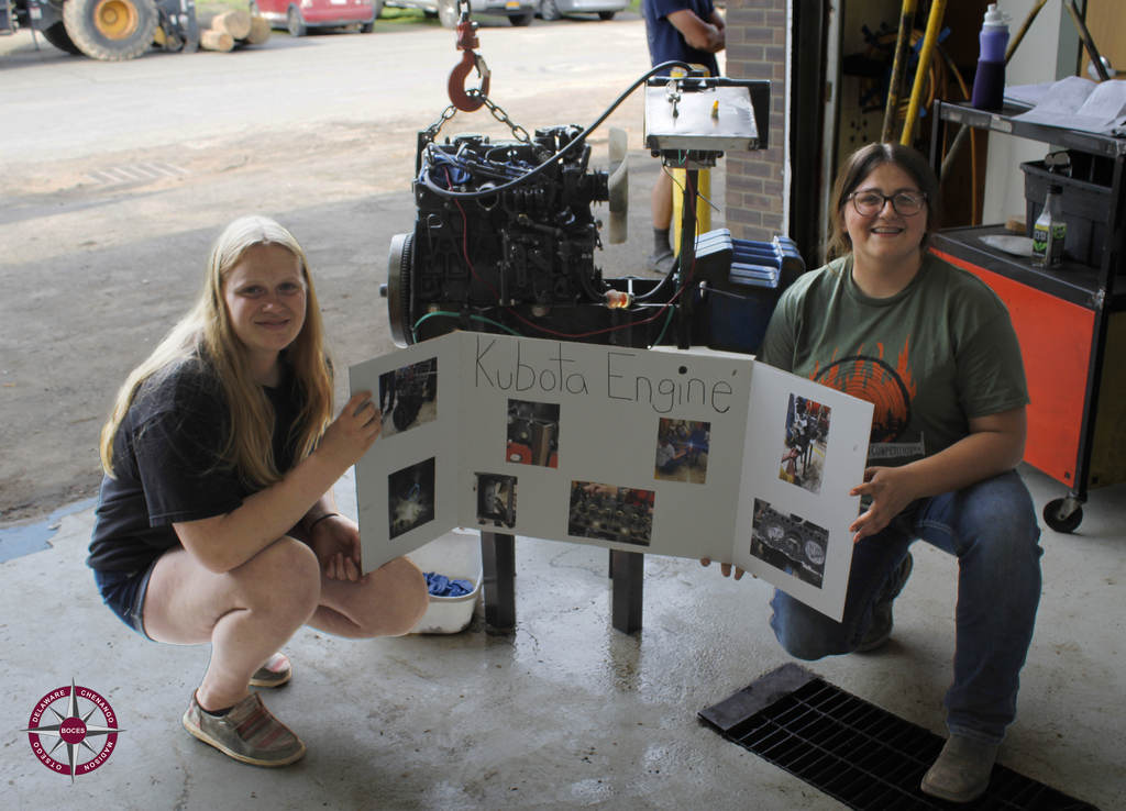 students kneel next to their Kubota Engine project