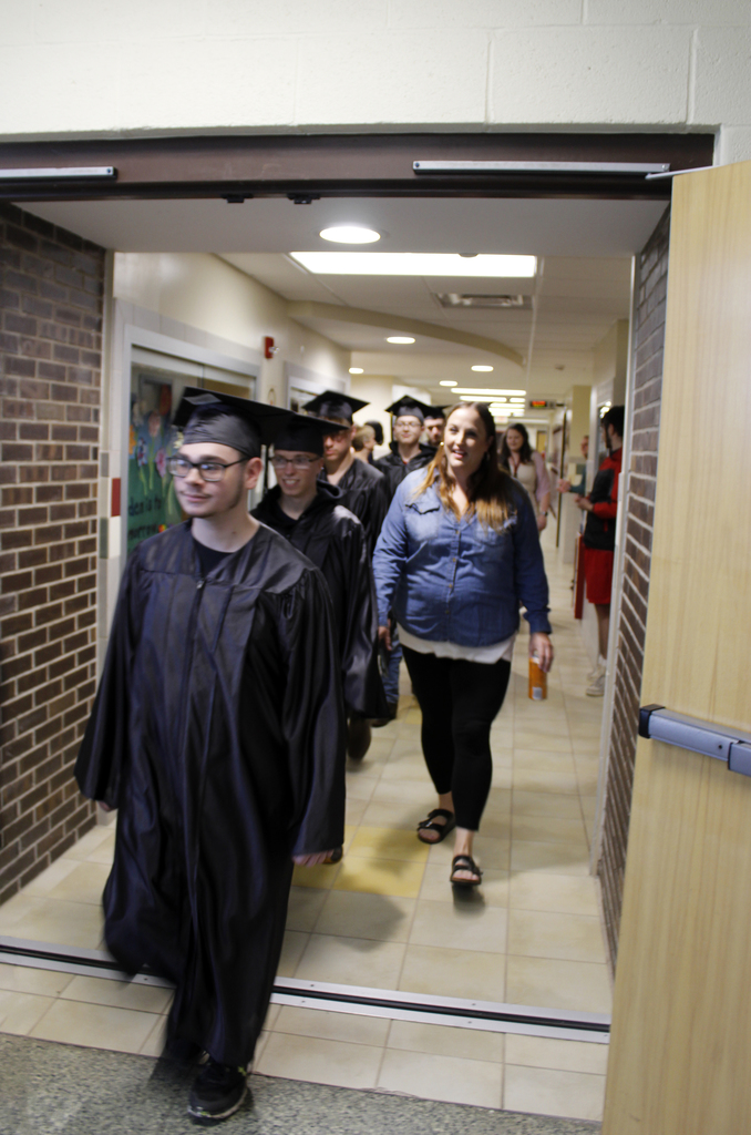 seniors and an adult walk in the hall