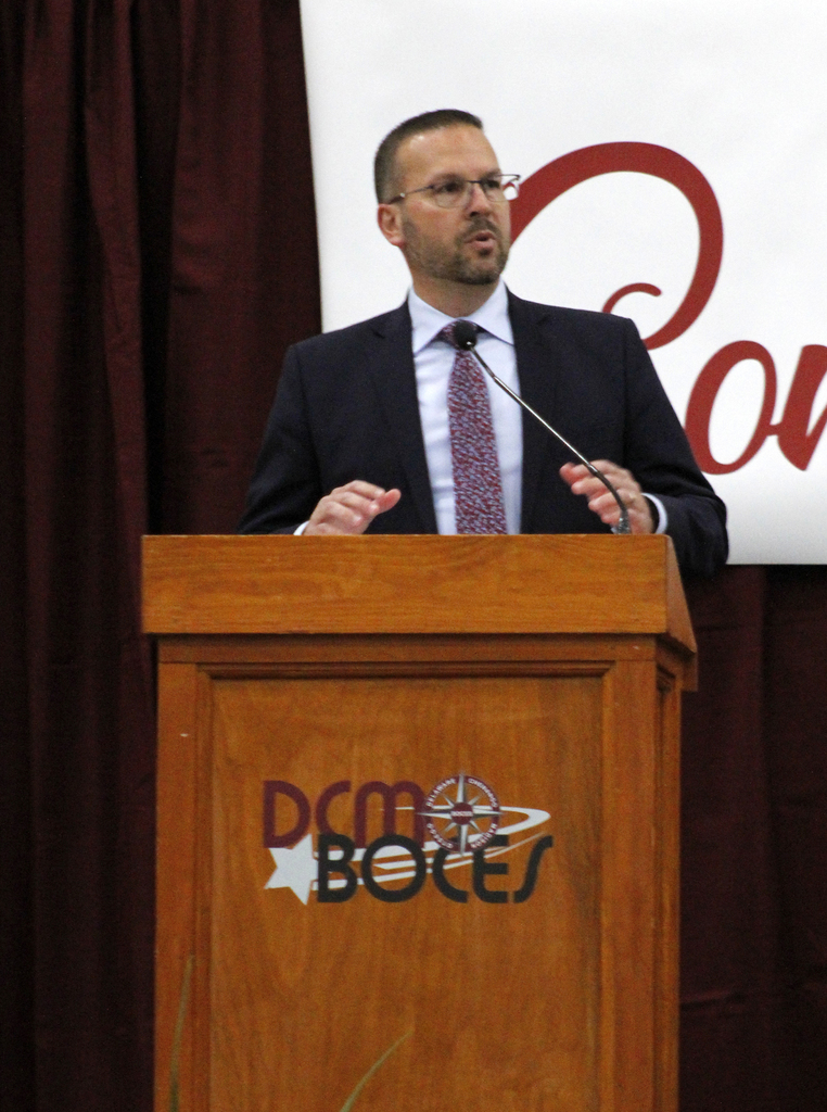 superintendent at lectern