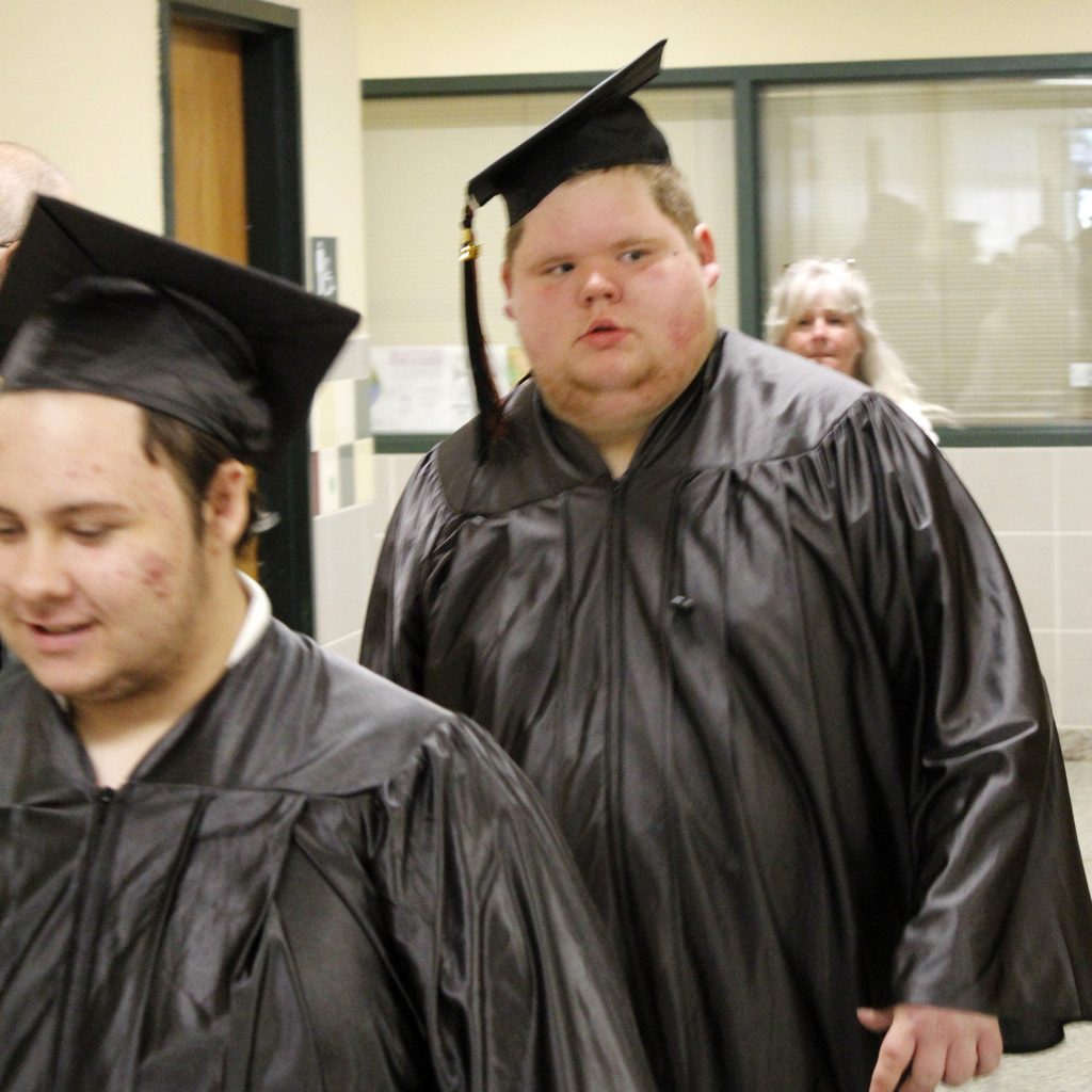 2 students in caps and gowns walking