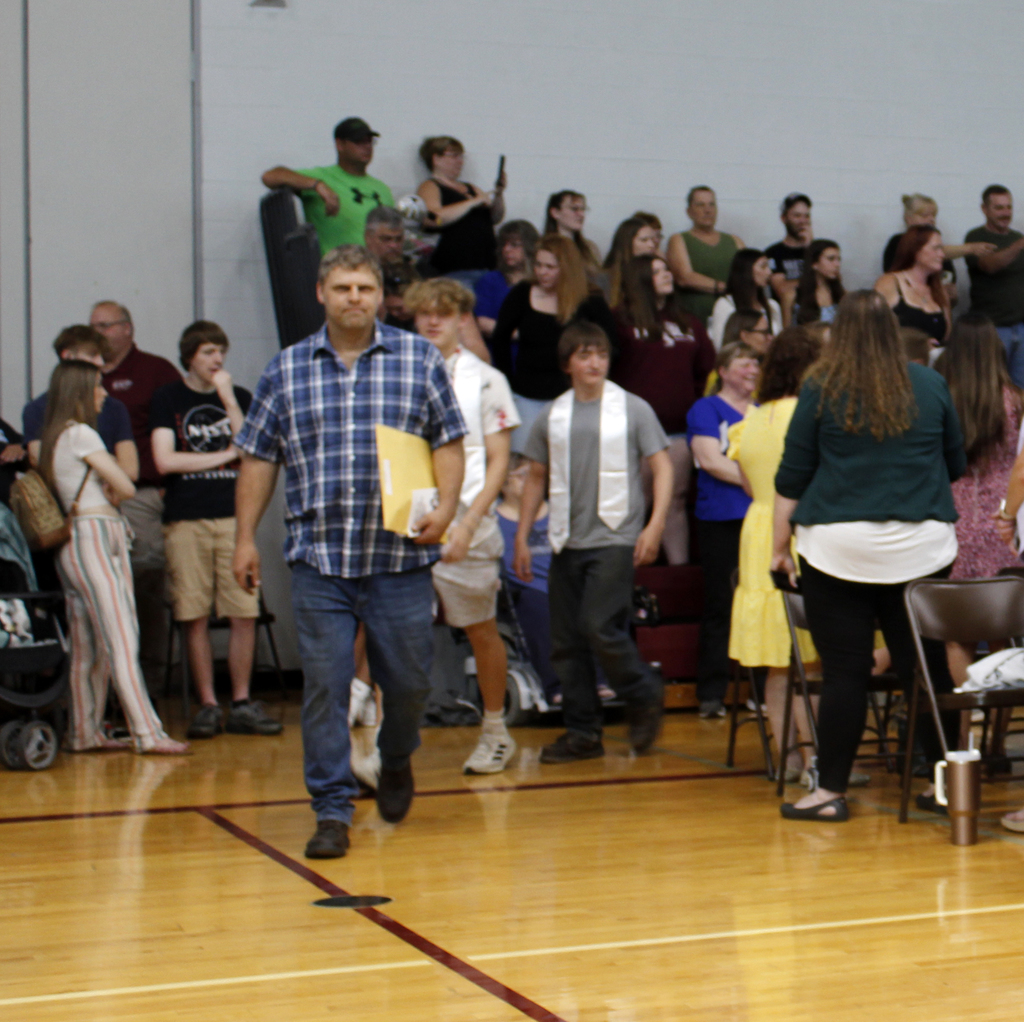 teacher leading his students in processional