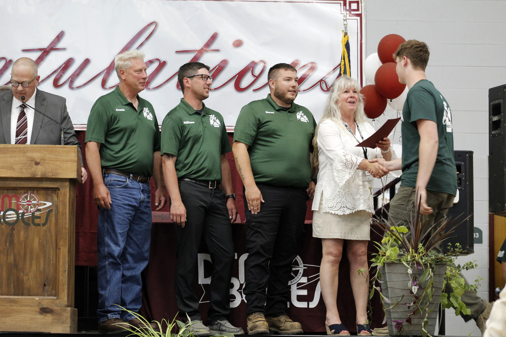 student receives certificarte from 4 adults