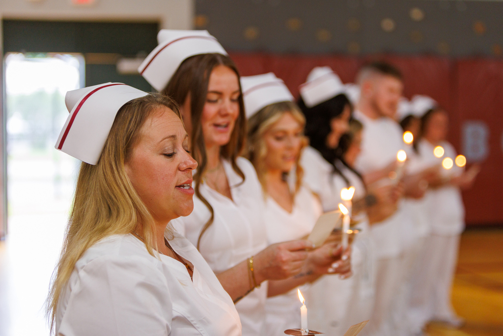 row of nursing students with candles