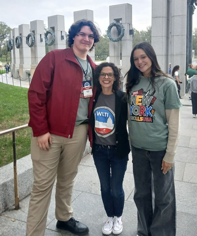 2 students and a SkillsUSA advisor at WWII memorial