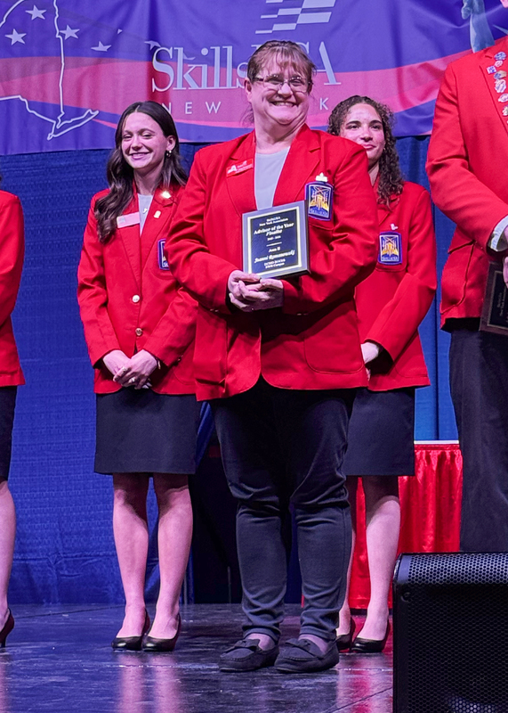 Jeanni Romanowski poses with award plaque
