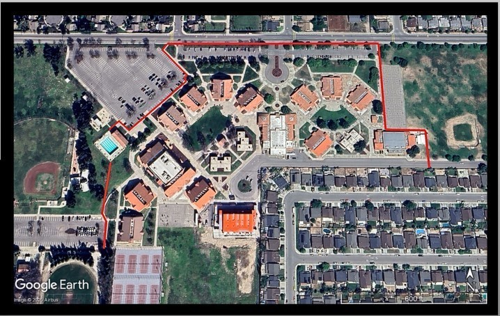 Image of aerial view of campus with red line outlining potential fence