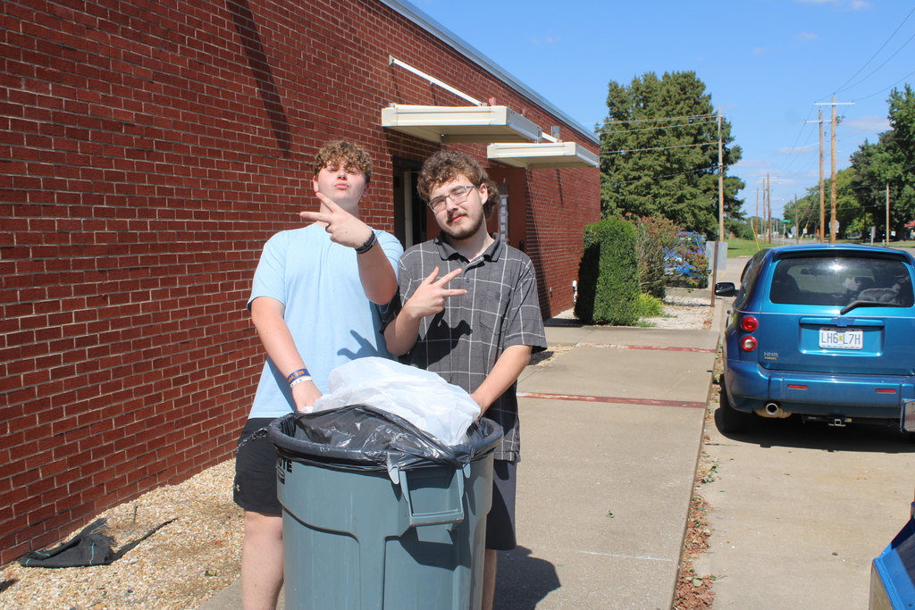 Boys posing with trash