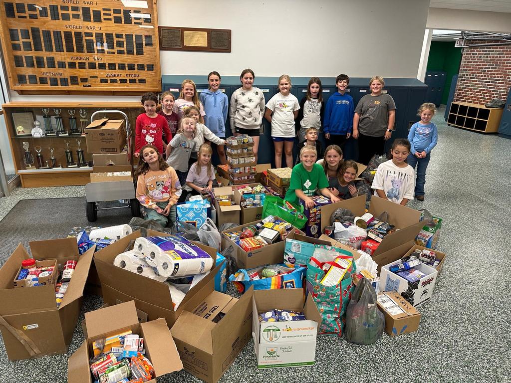 group of students standing near boxes of food
