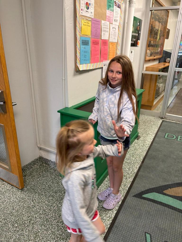 Principal Ingersoll giving high fives in the morning