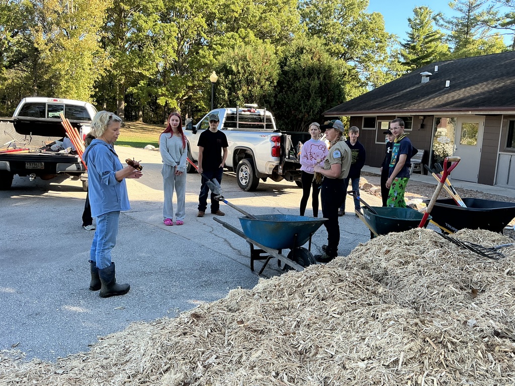 Helping spead mulch.