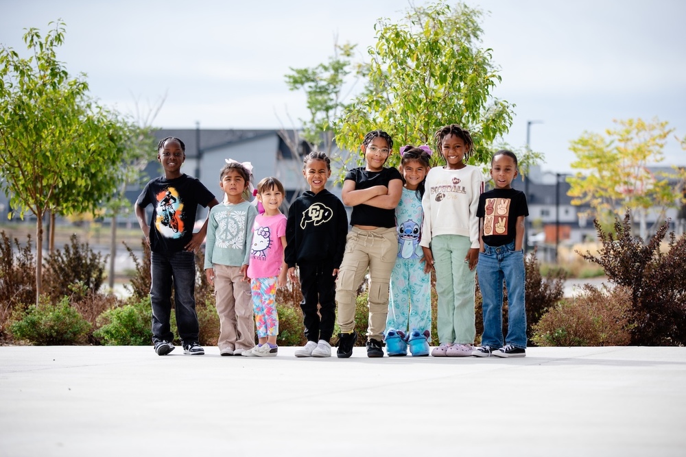 group of students standing in a line and smiling on a playground