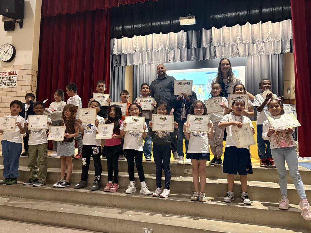 Students with awards on stage