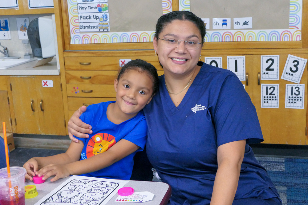 An Ellis student and their caregiver pose for a photo at Back to School Night.