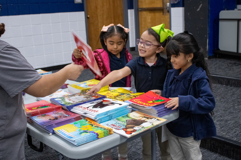 Students pick three free books to take home with them.