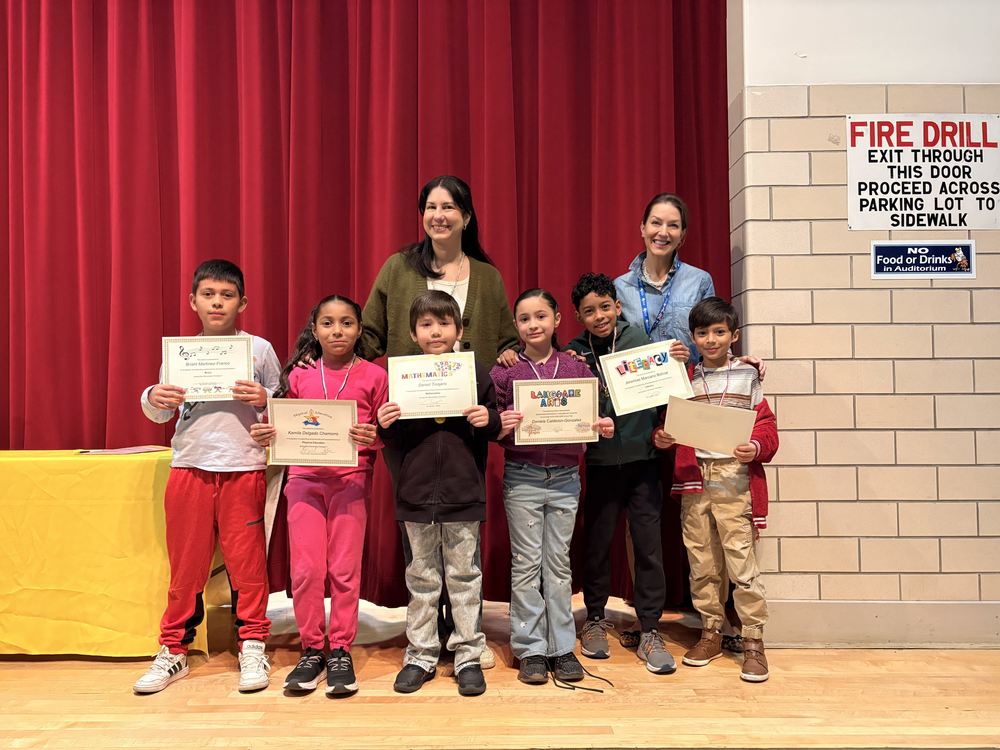 Students pose with their certificates at the Trimester Awards.