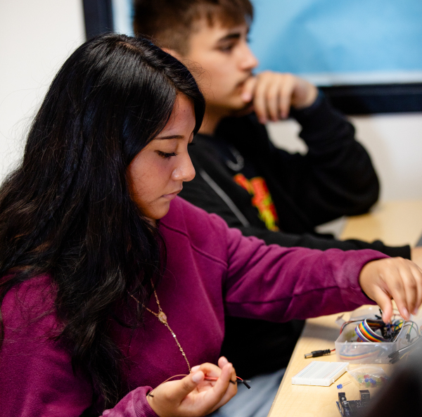 NEC student works at her desk