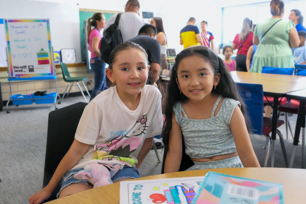 Two students smile at Back to School Night.