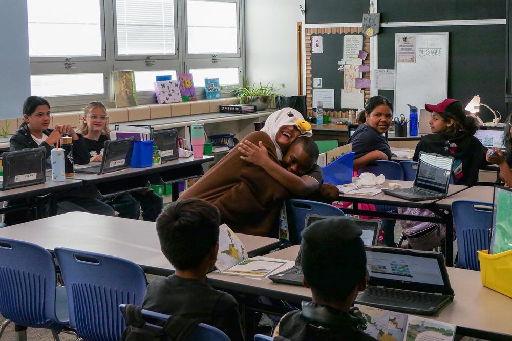Eagle mascot hugging student