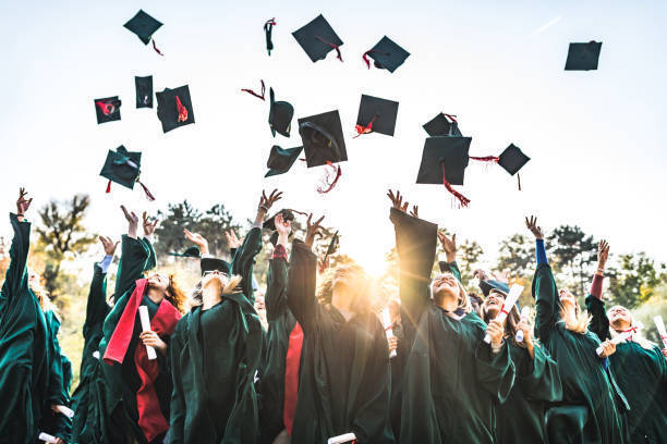 Picture of students throwing their graduation caps into the air.
