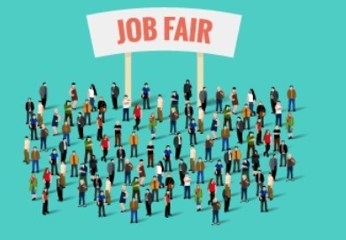 Many people standing in front of a job fair sign. 