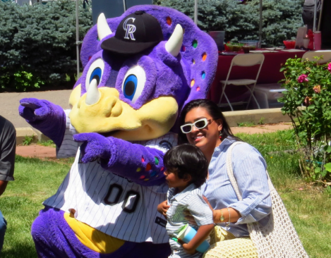 Dinger the Rockies' mascot with a fans
