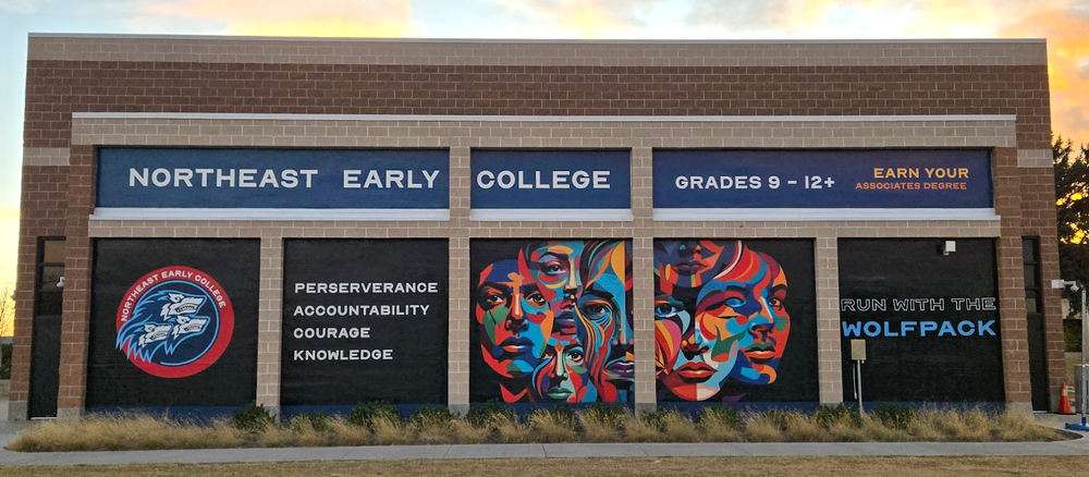 Exterior of Northeast Early College with a mural of colorful faces, the NEC logo, and the words "Perseverance, Accountability, Courage, Knowledge" and "Run with the Wolfpack"