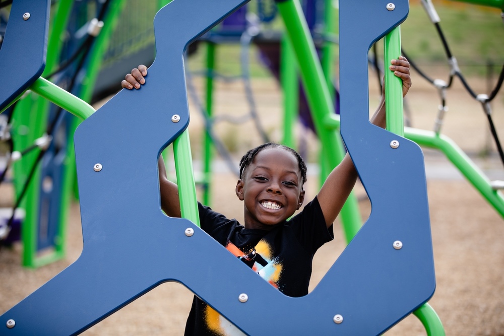 student smiling and playing on playground