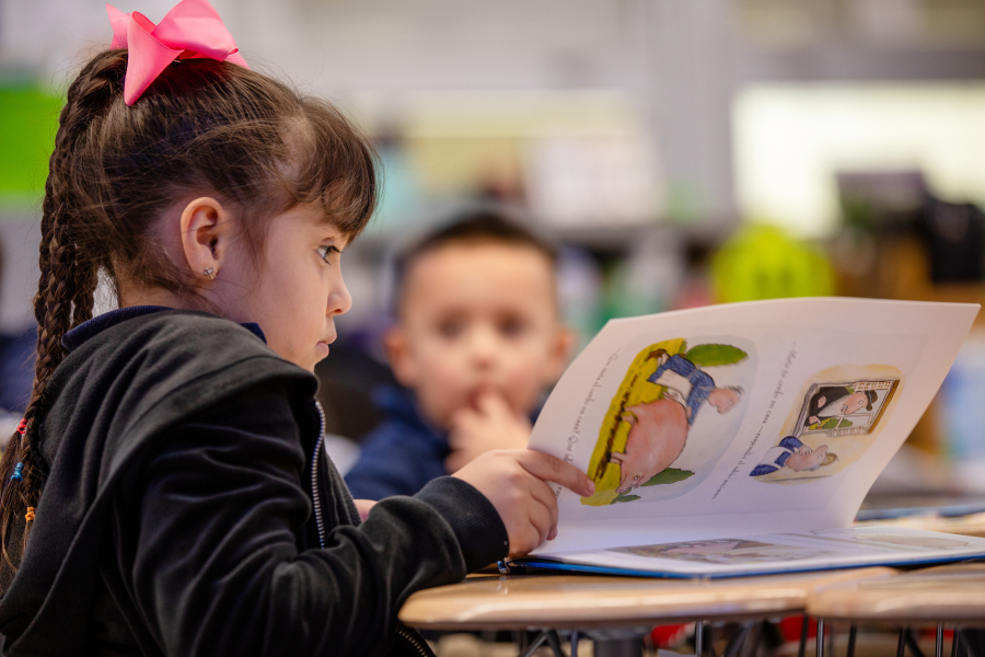 Student reading through a book 